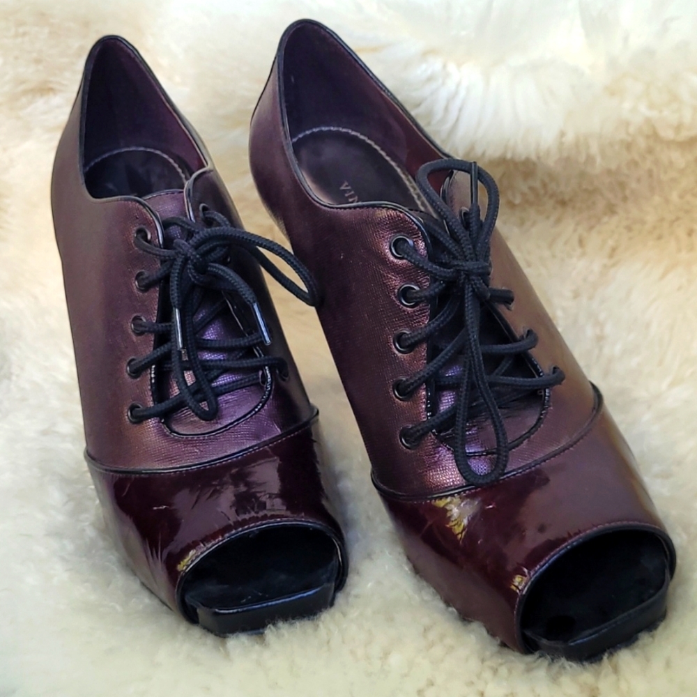 Vince Camuto patented leather peeptoe platform lace-up booties.